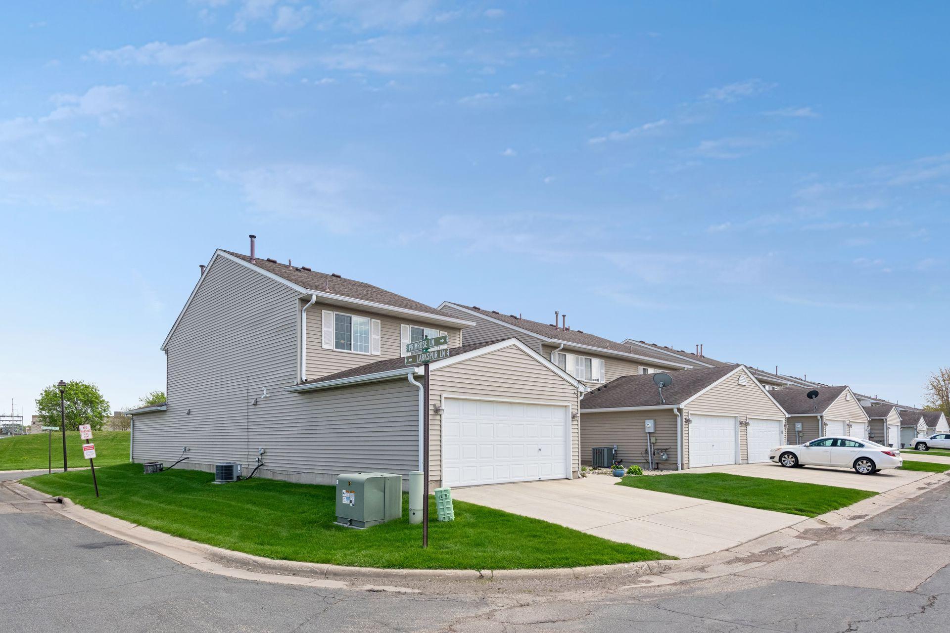 This corner TH features newer concrete driveway