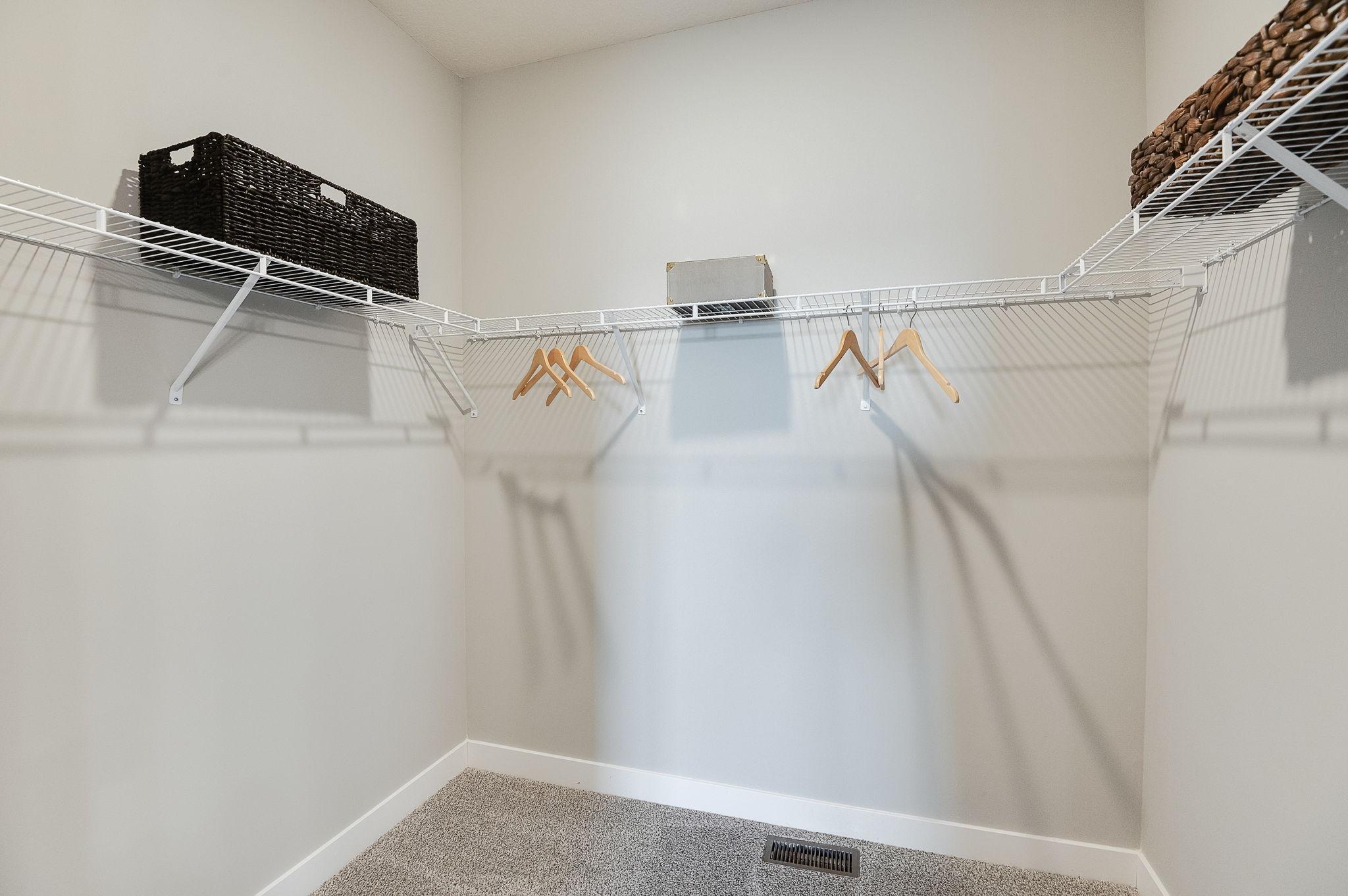 Primary suite with dedicated bathroom and expansive closet. Model home, finishes will vary.