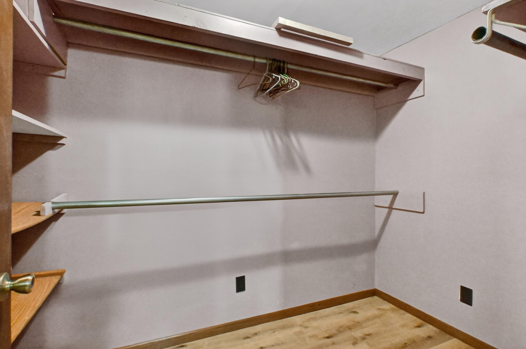 walk in closet in lower level bedroom