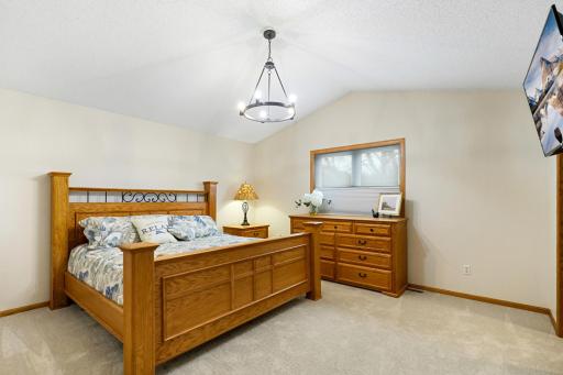 Large primary bedroom with new lighting, carpet and paint