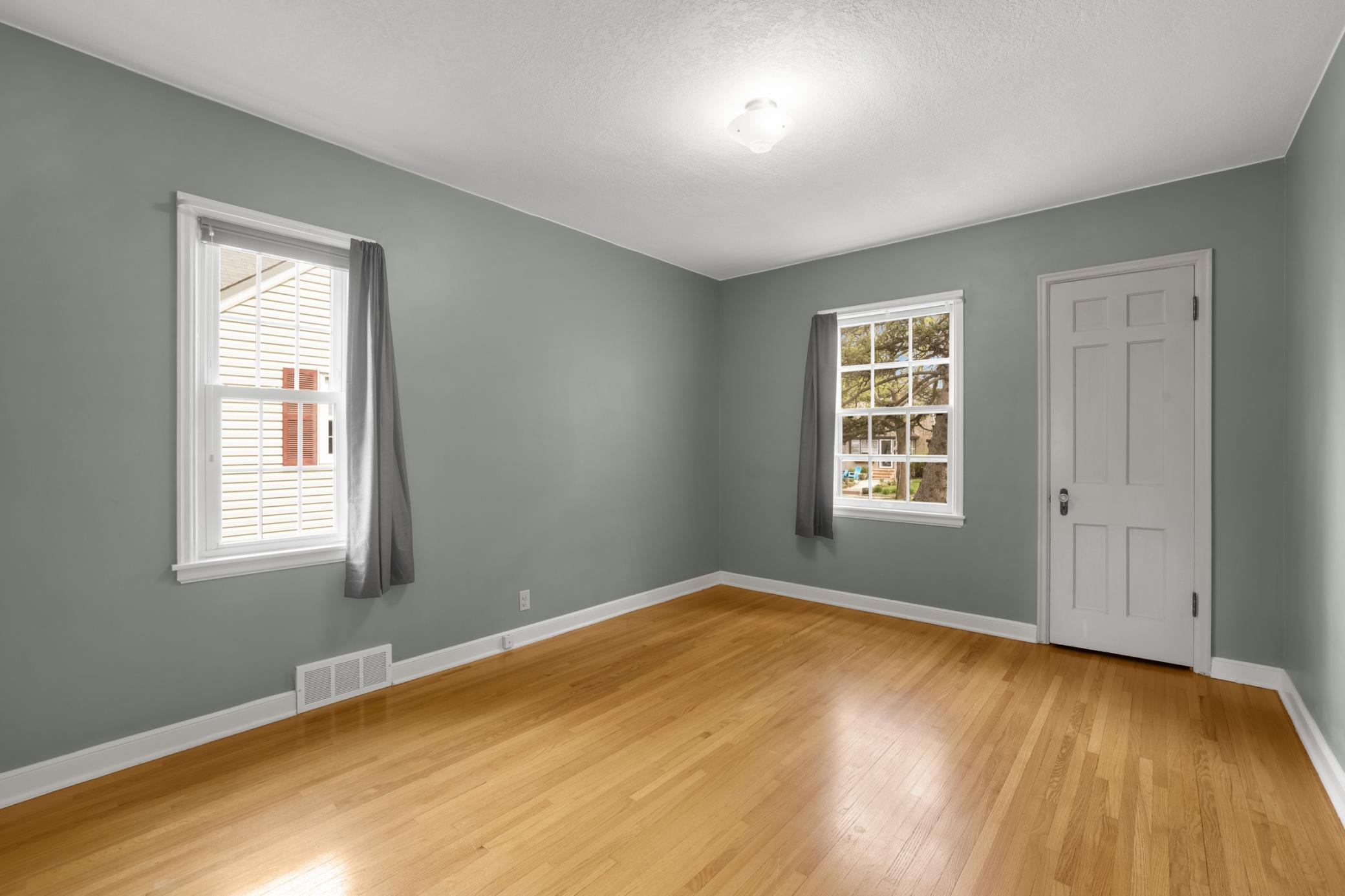 The spacious main-level bedroom #1 could be your primary bedroom or a great flex space!