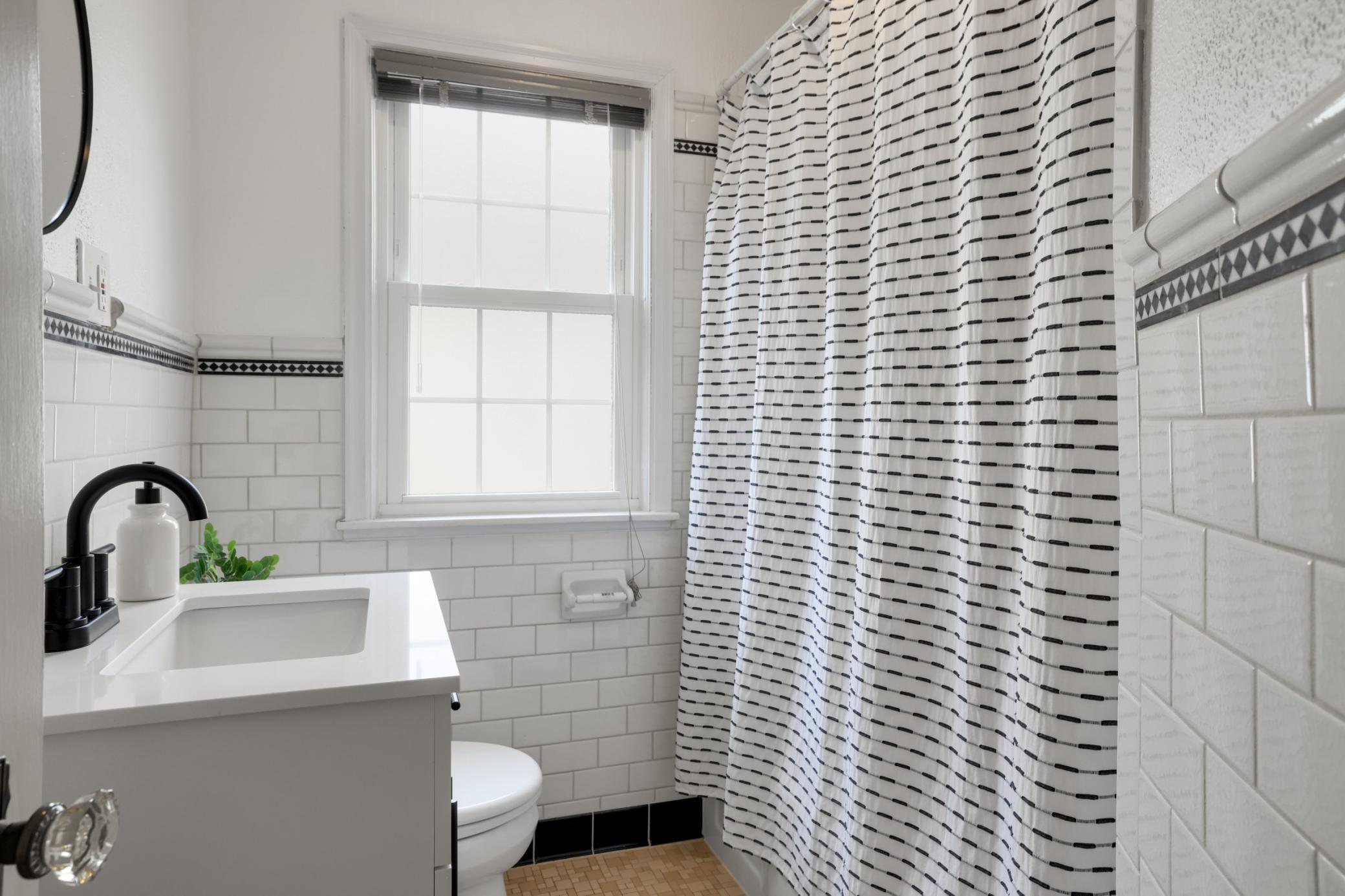 The main floor bathroom was updated in 2025 with a new vanity, paint, and lighting.