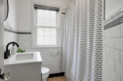 The main floor bathroom was updated in 2025 with a new vanity, paint, and lighting.