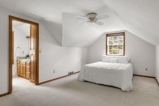 The spacious upper level primary suite with an ensuite bathroom