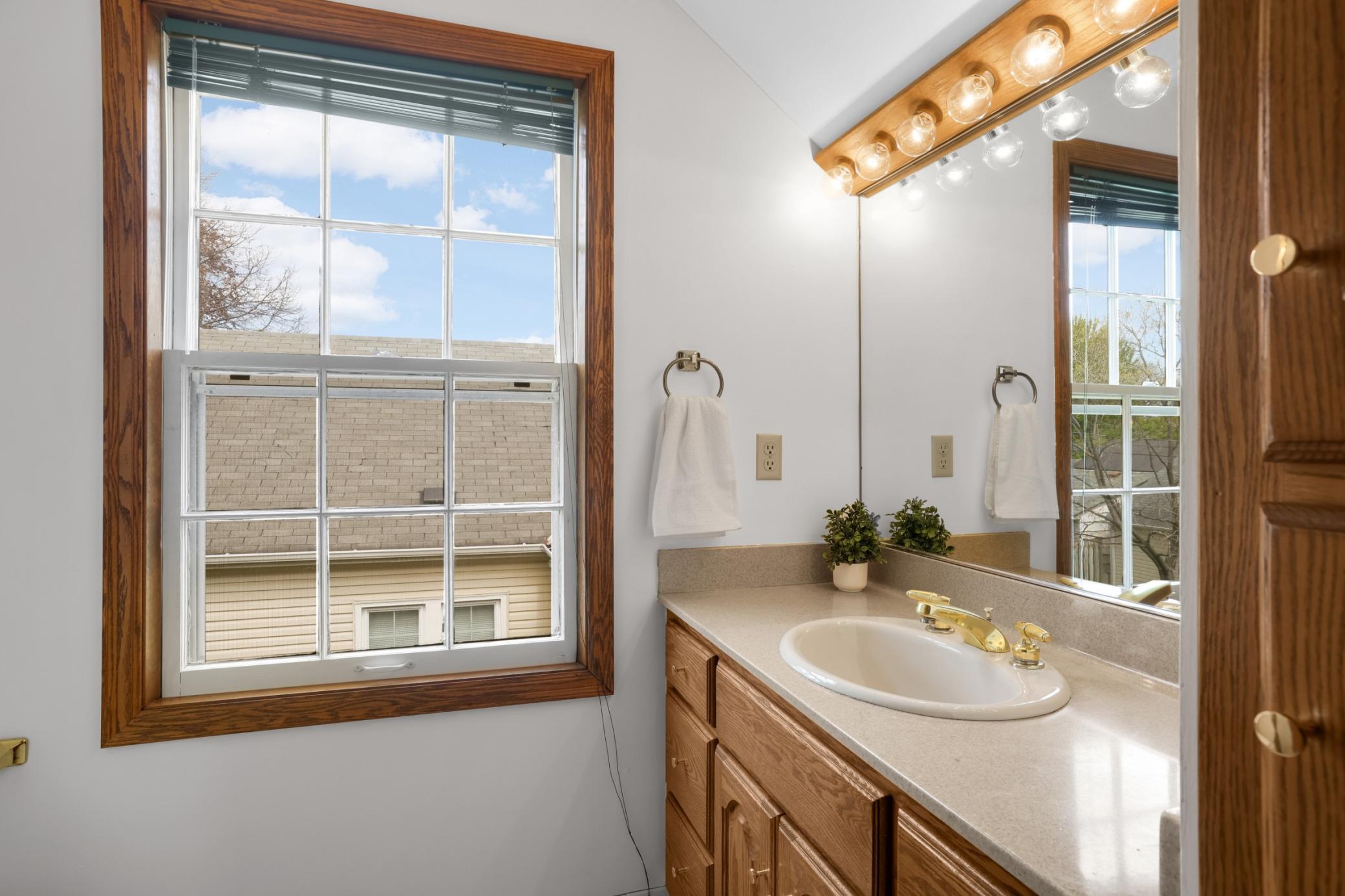 The primary 3/4 bathroom has fantastic lighting, making it the perfect spot to get ready in the morning.
