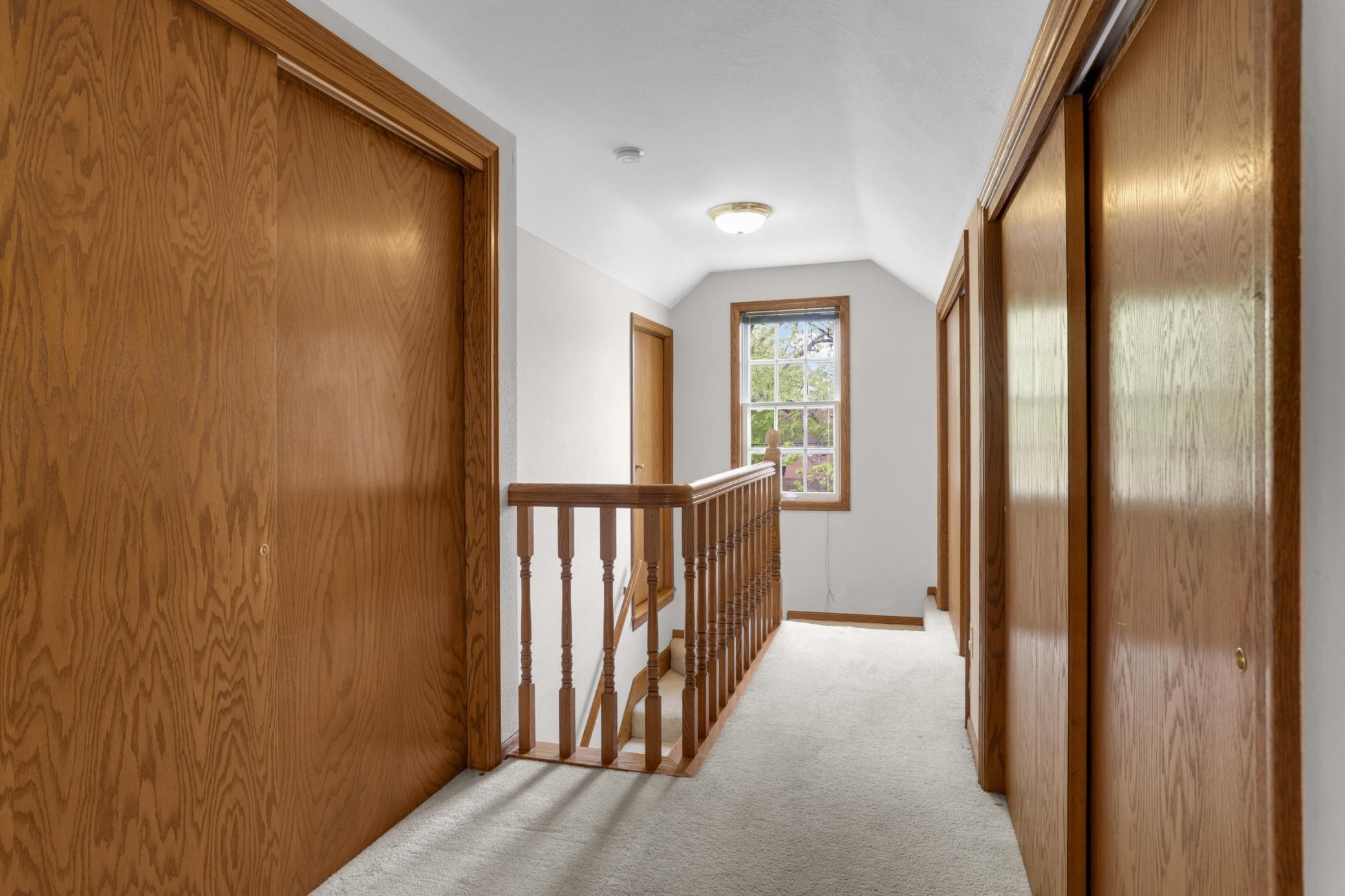 The upper level primary suite features ample closet space and high ceilings (a rare find!)