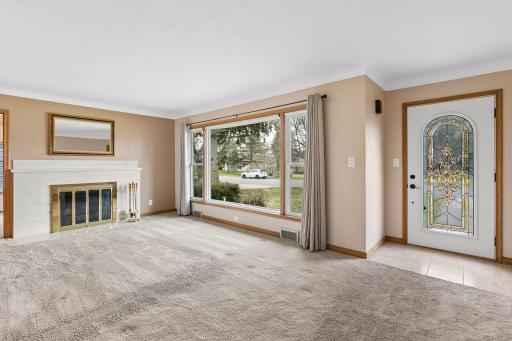 The living room boasts a large newer (Anderson) west facing window.