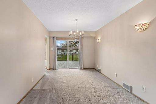 The dining room is super spacious and leads out to deck and into kitchen.