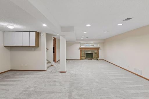 The carpet is newer down here and there is a second fireplace.