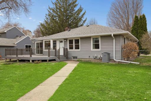 The sidewalk from the backdoor leads out to the yard and two car garage.