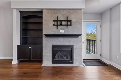 Gas fireplace with tile surround and built-in.