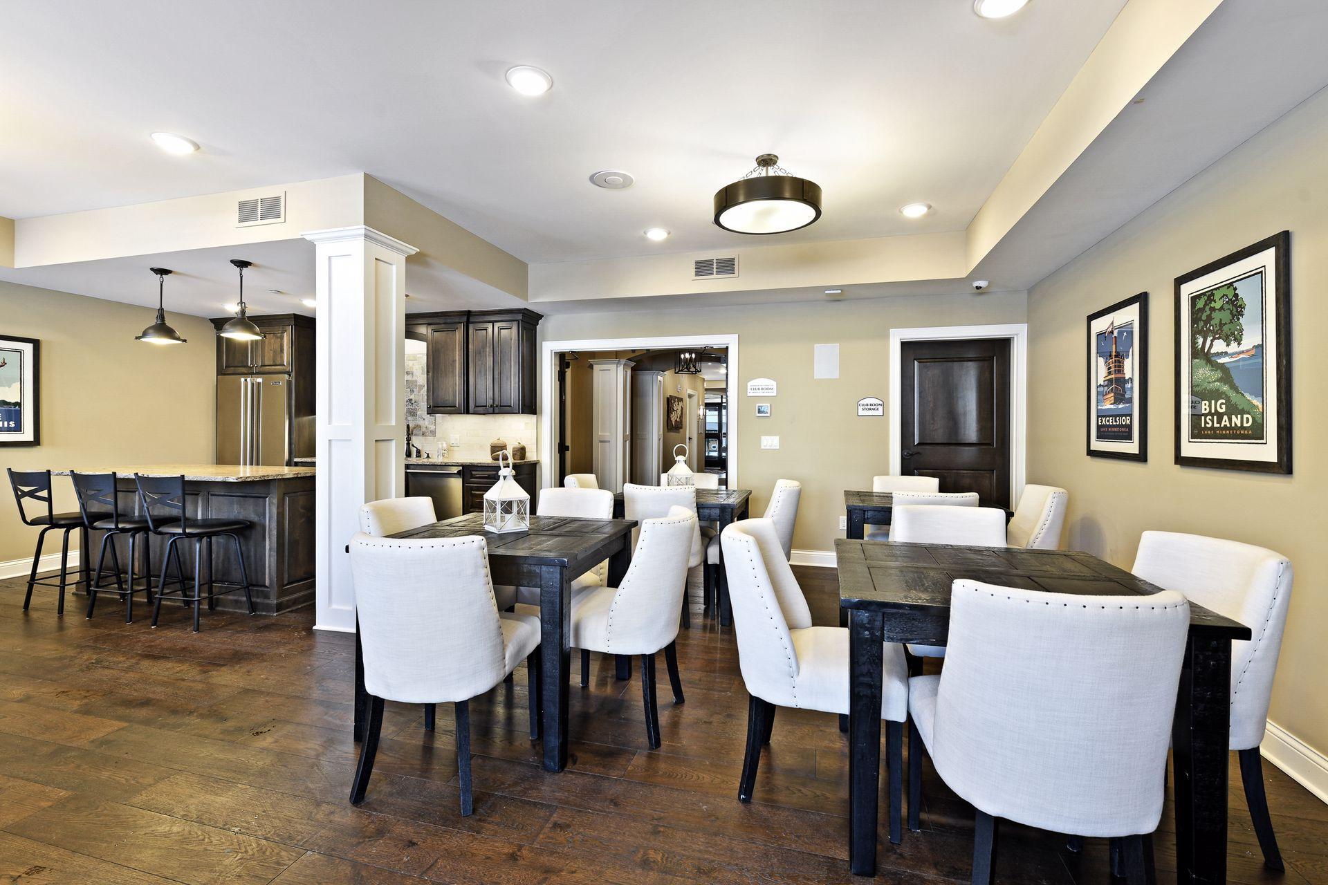 Spacious community club room with a comfortable sitting area plus tables and chairs — ideal for entertaining, gatherings, or casual get-togethers