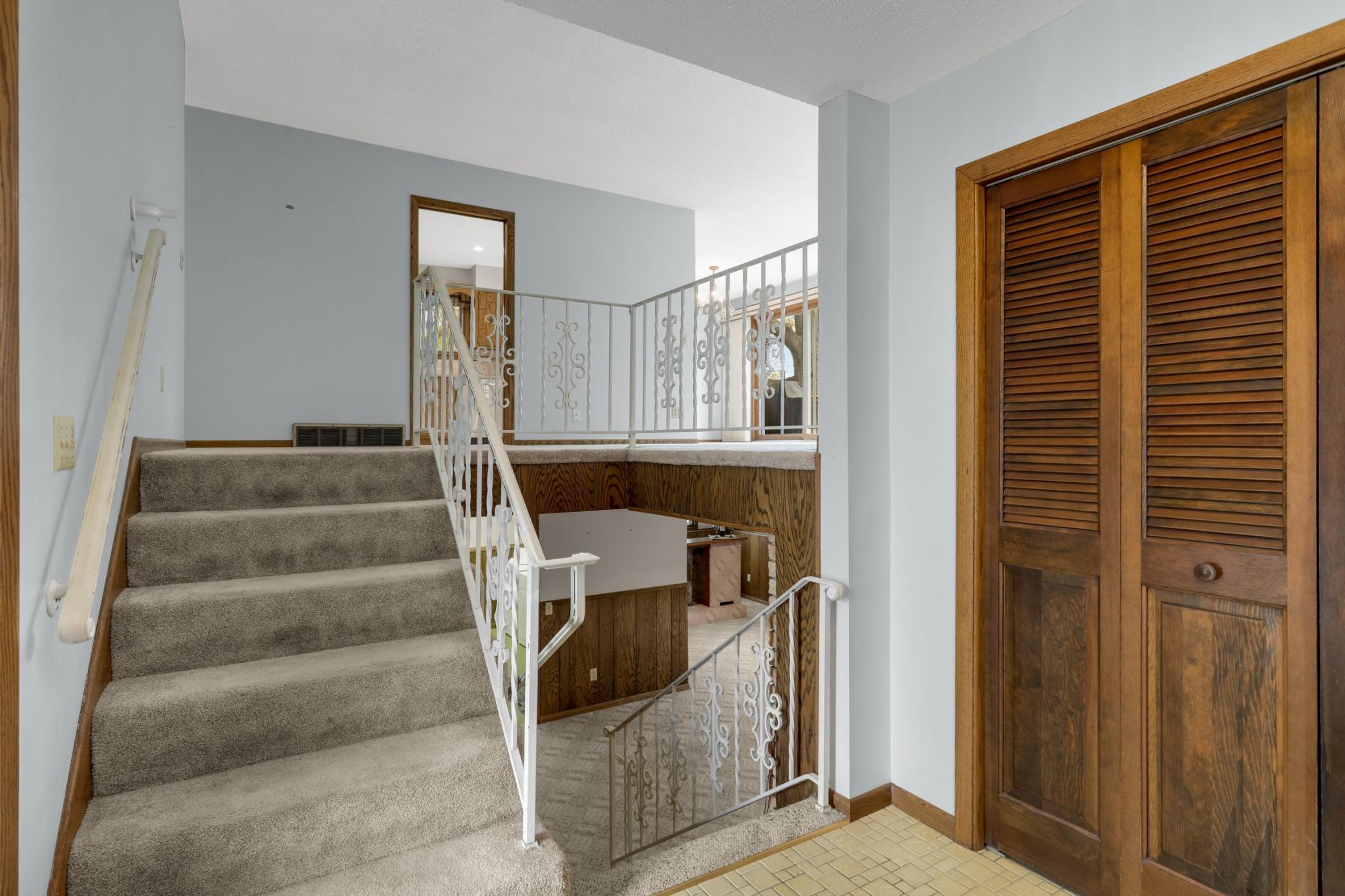 Open stair case with wrought iron railings. Good sized entry way and closet.