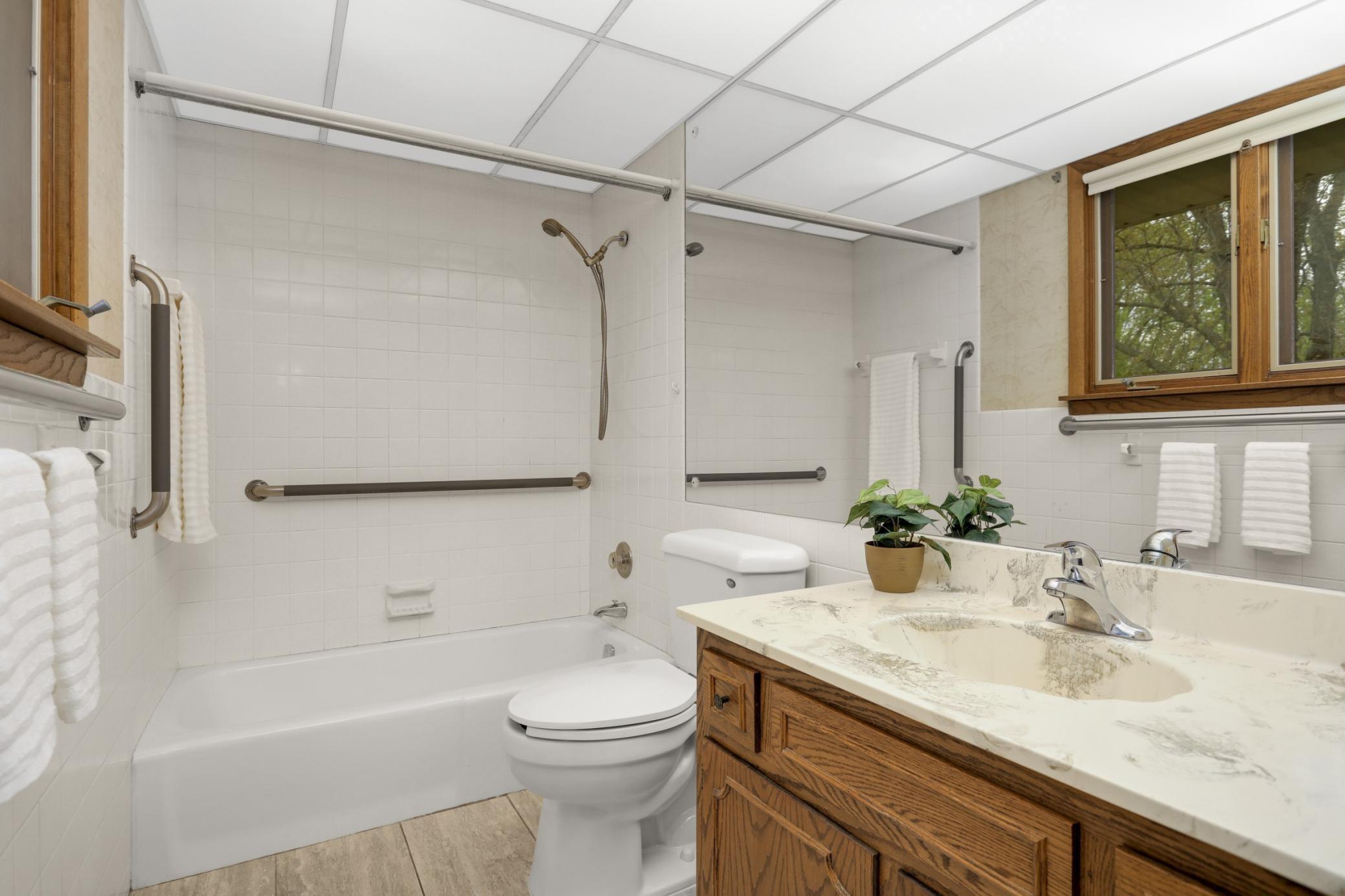 Primary private full bathroom with great view of pond.