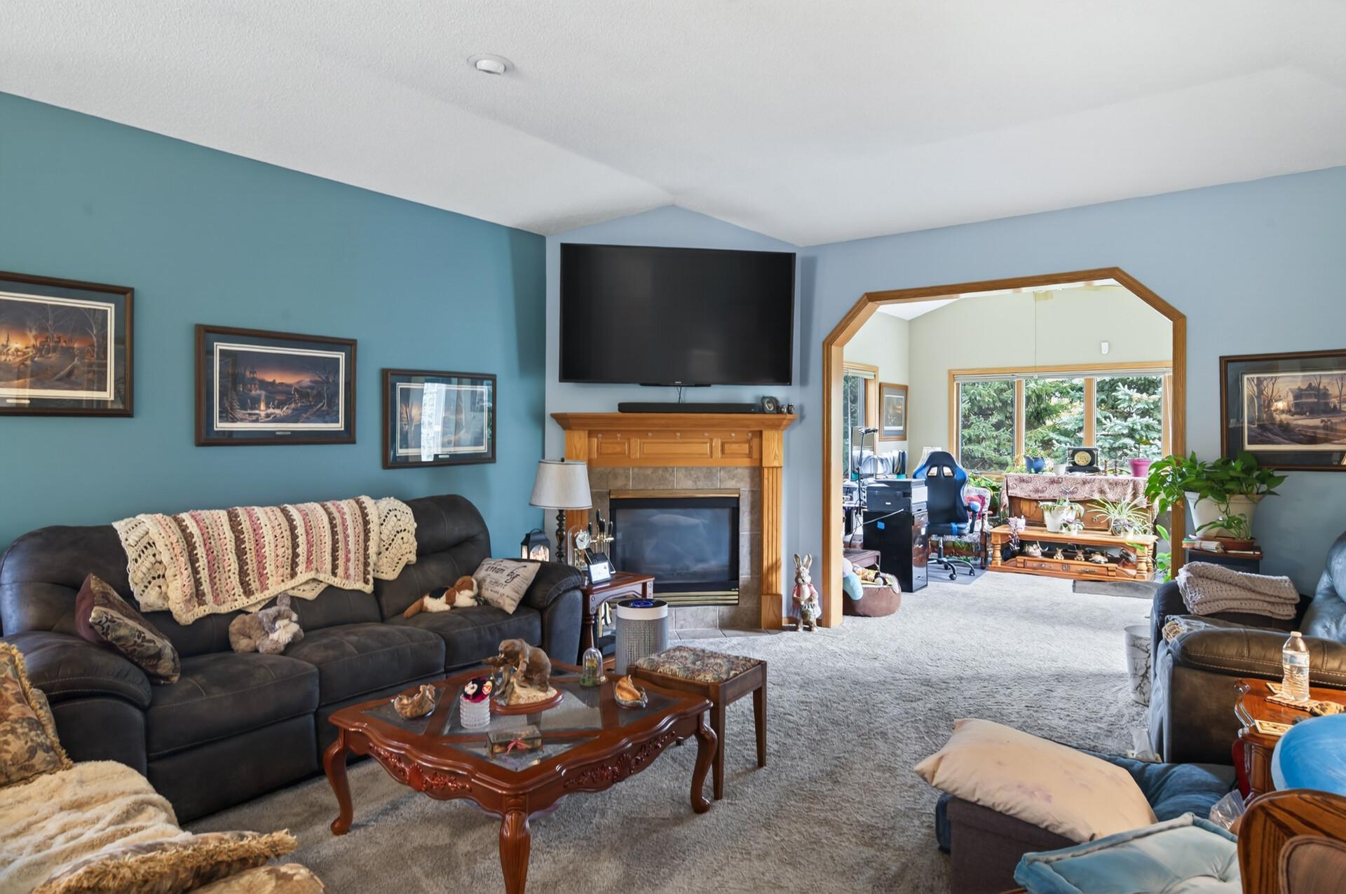 The living room is centered around a gas fireplace adding warmth and a cozy ambiance.