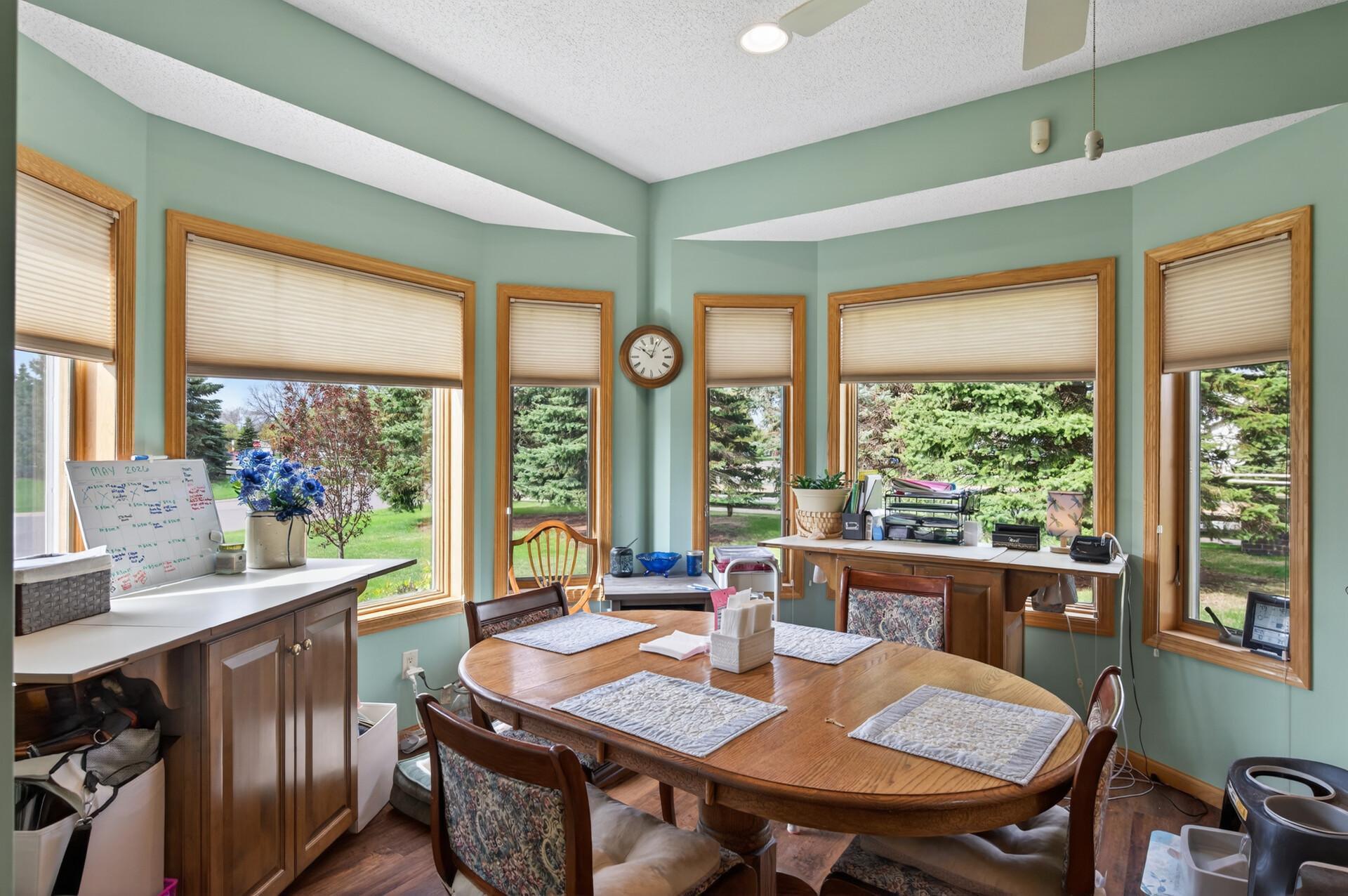 The informal dining area and kitchen is flooded with natural light with surrounding windows!