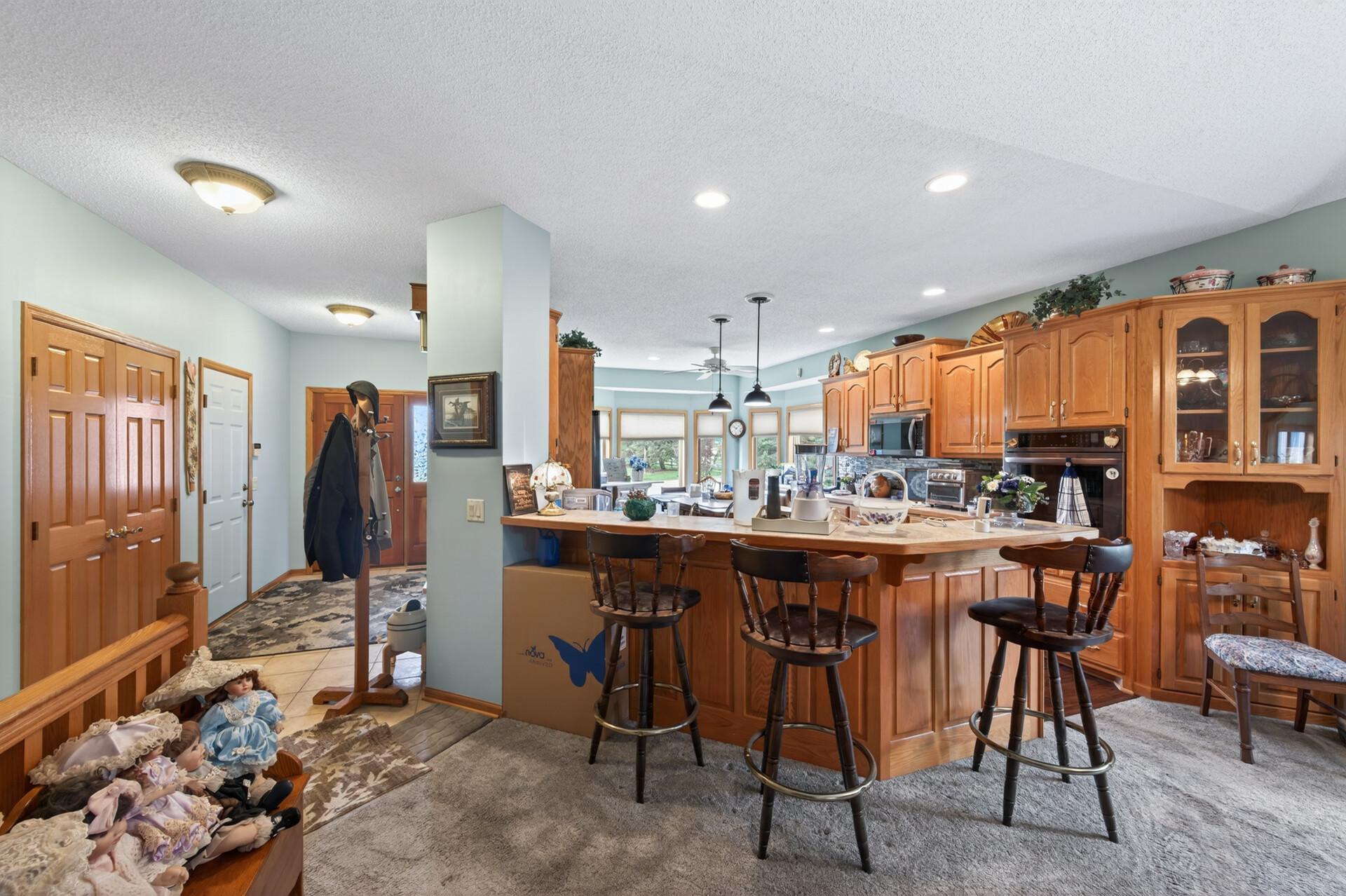 The generous kitchen boasts rich wooden cabinetry with abundant storage/prep space!