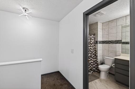 The upper level bathroom is conveniently located near each bedroom, making morning routines simple and efficient.