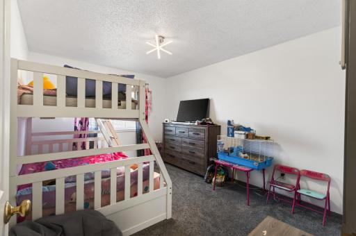 Second upper level bedroom also offers carpeting and natural light.