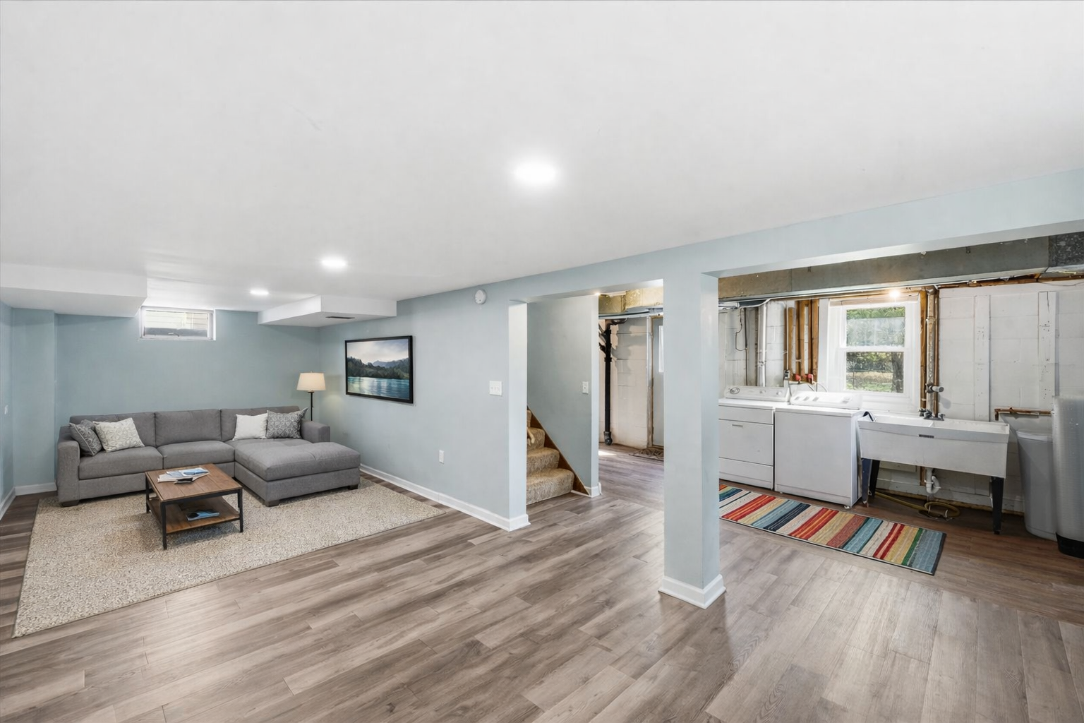 Digitally enhanced to showing family room area. Laundry room also has digital enhancements