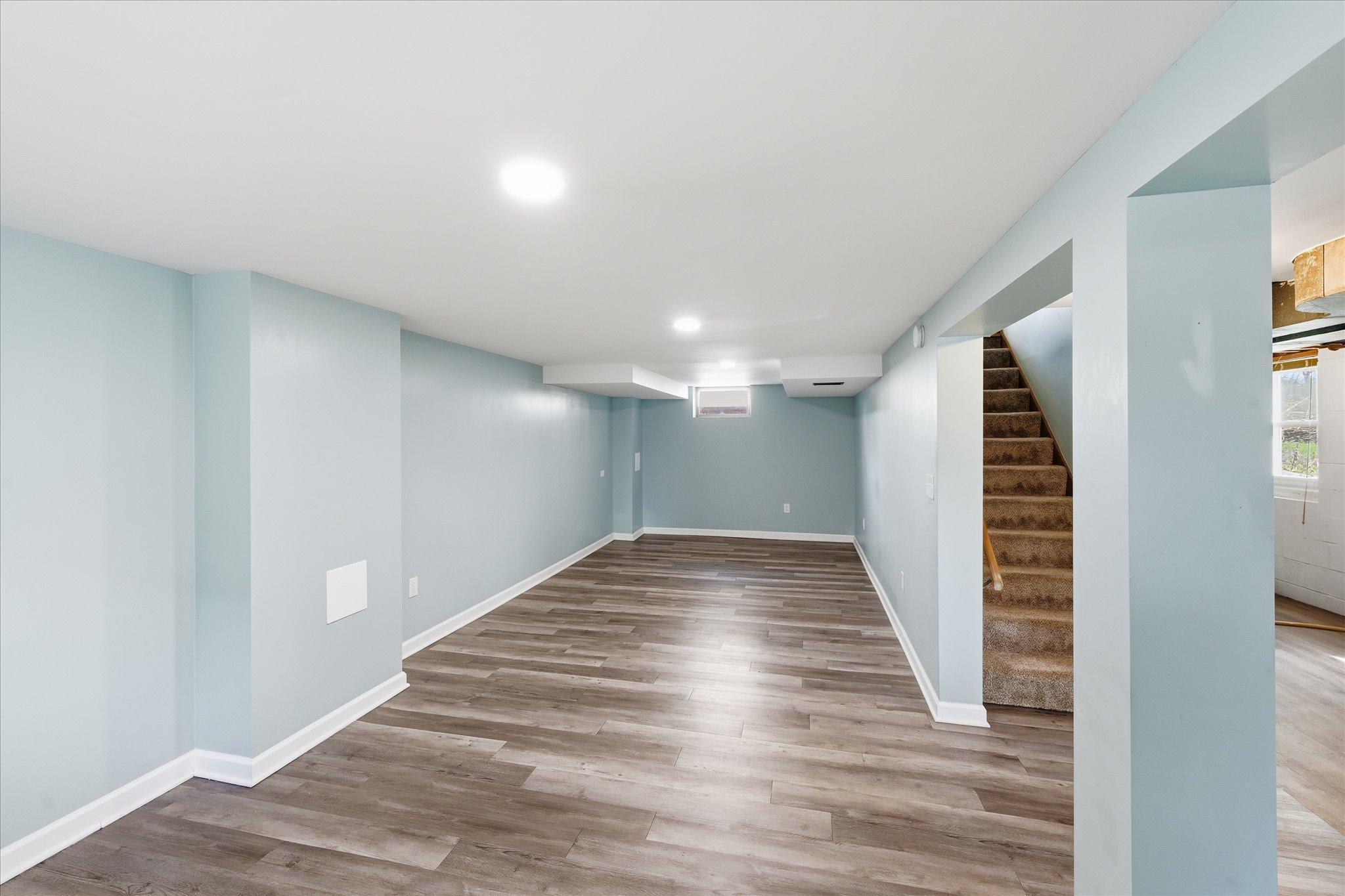 Notice the additional natural light coming from the upper level. You won't feel like you are going to a dungy basement here!! Plenty of usable space, storage, functionality and walk out to private backyard!