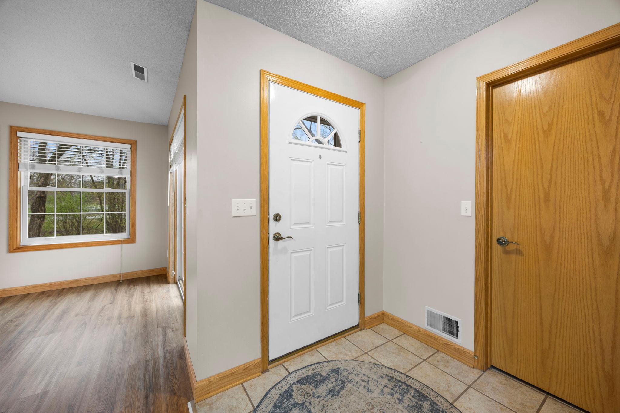 The door on the right is a walk-in closet for your 4-seasons of jackets, shoes and boots! The door to the garage is conveniently located next to this closet, also.