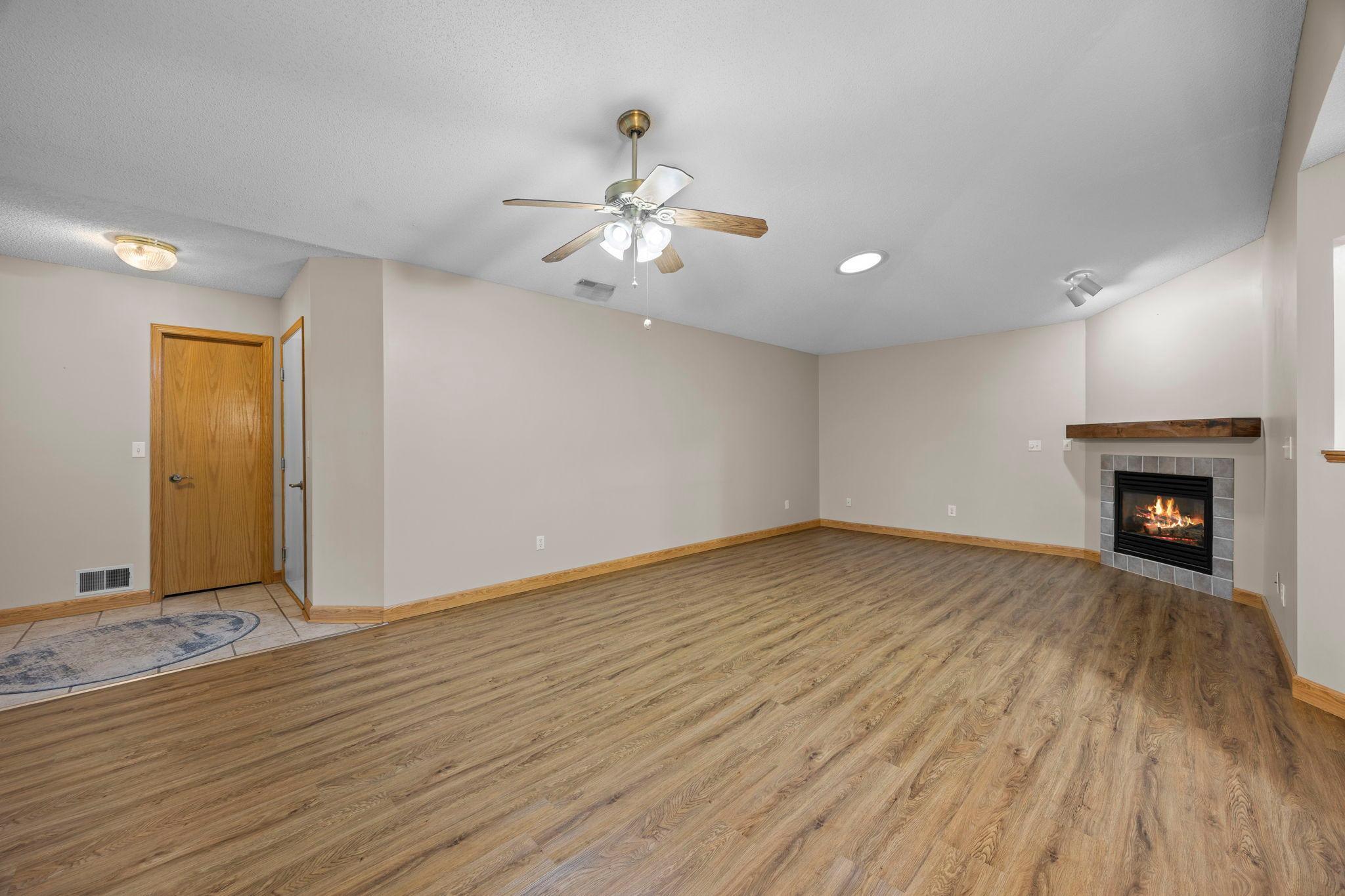 Sunroom to living view. You have plenty of space for large furniture. You can see the solar tube in the living room ceiling.