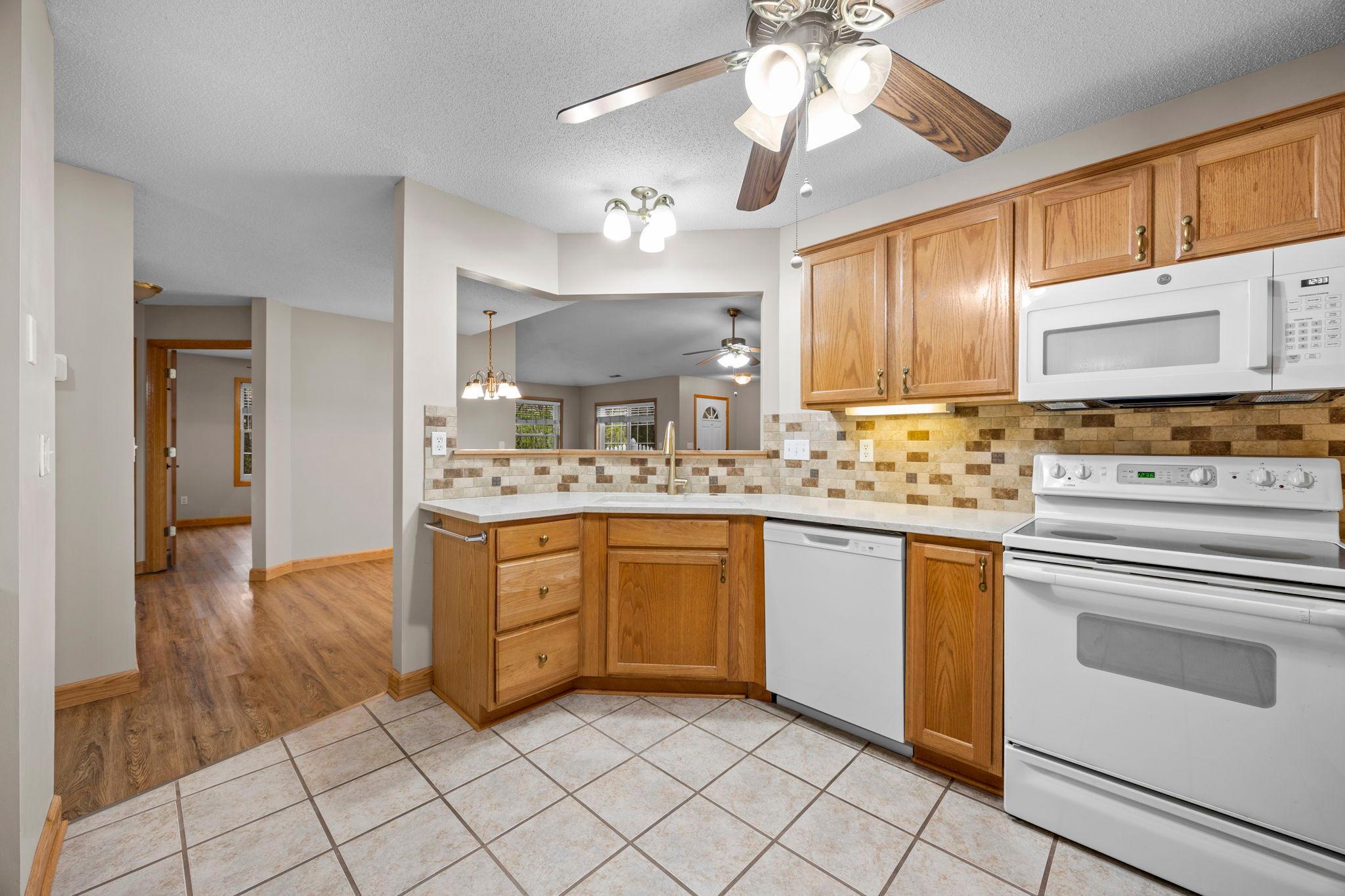 There is a small bar counter at the sink area.