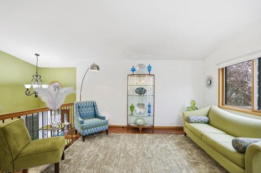 Exotic hardwood floors add a layer of warmth and sophistication, while an abundance of natural light keeps the space feeling bright, open, and endlessly welcoming.