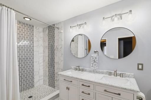 At the heart of the primary suite is a remodeled ensuite bathroom that is nothing short of stunning.