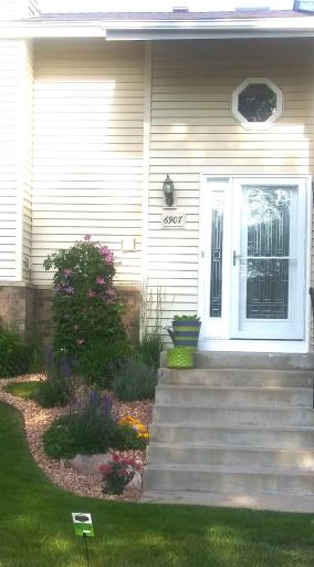 Lovingly tended gardens and mature trees make this exterior as inviting as the interior.