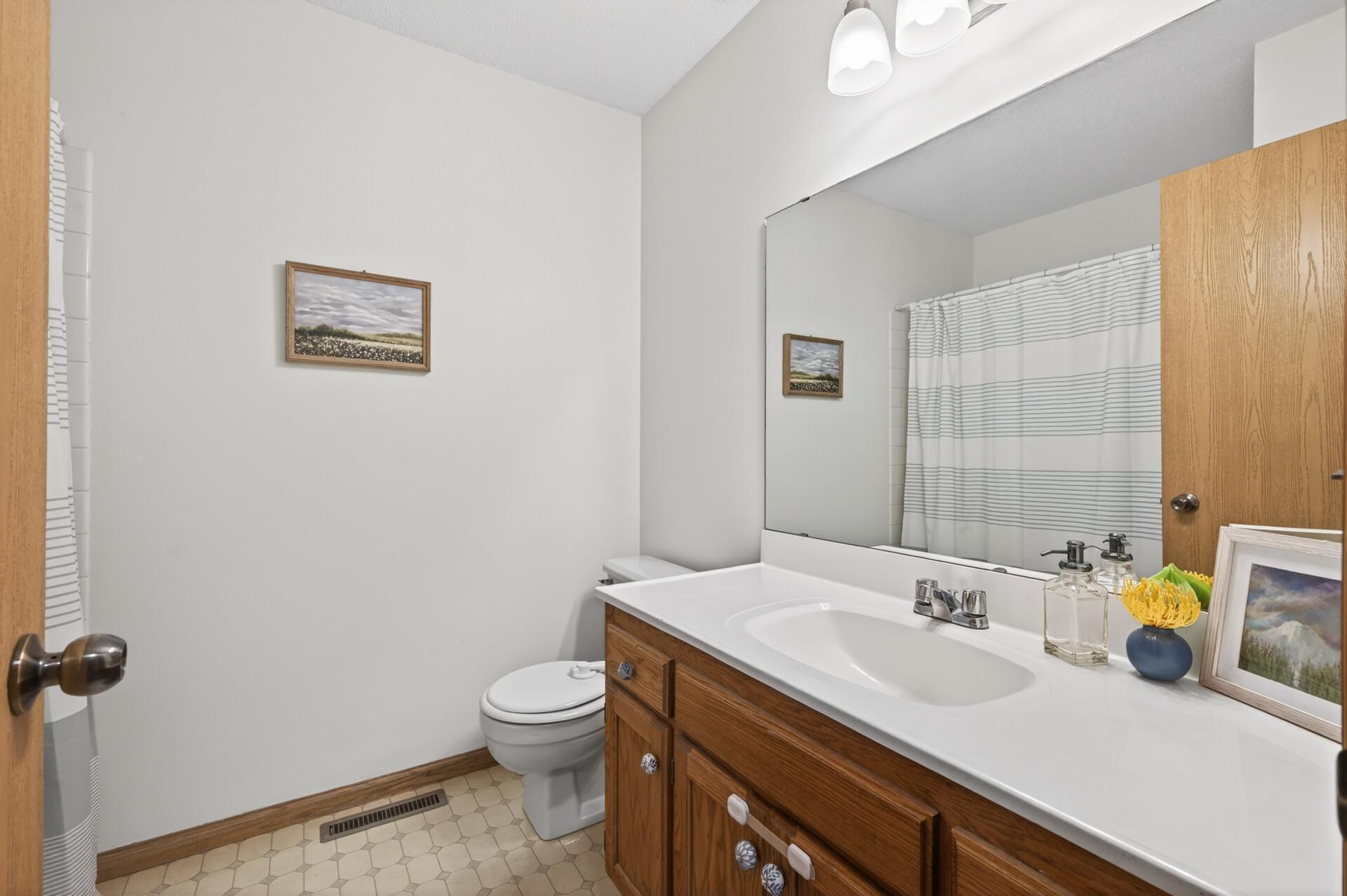 Upper level full bath with oversized vanity.