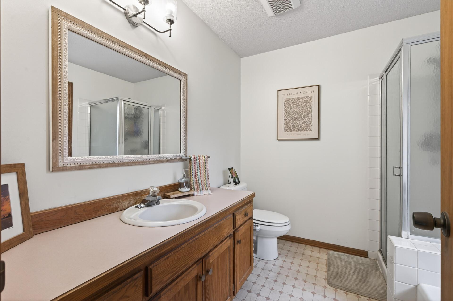 Primary ensuite complete with oversized vanity with plenty of counter space & storage, separate walk-in shower & tub.