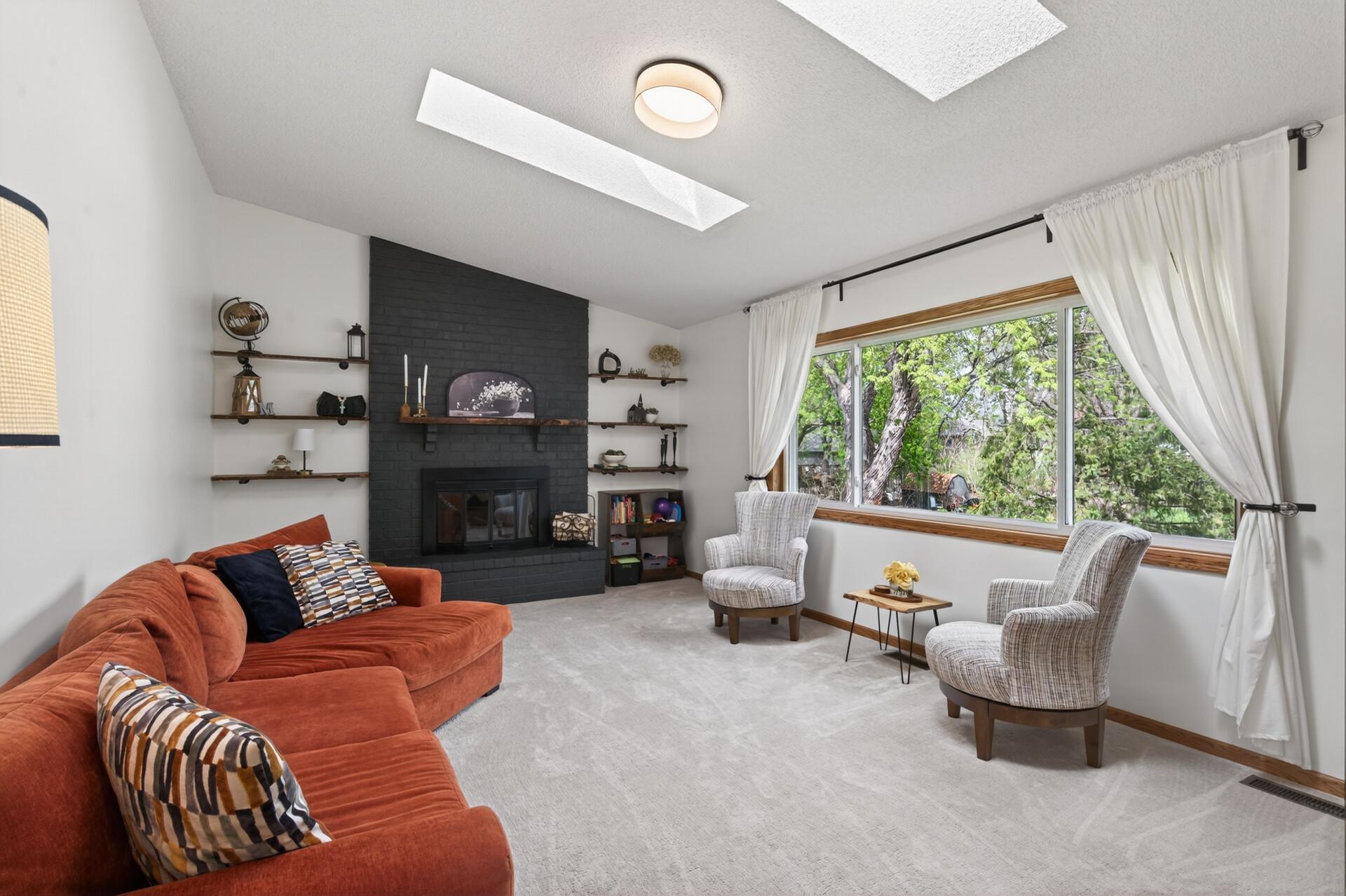 Vaulted ceilings make this family room bright & airy and the gas fireplace adds a striking, warm contrast.