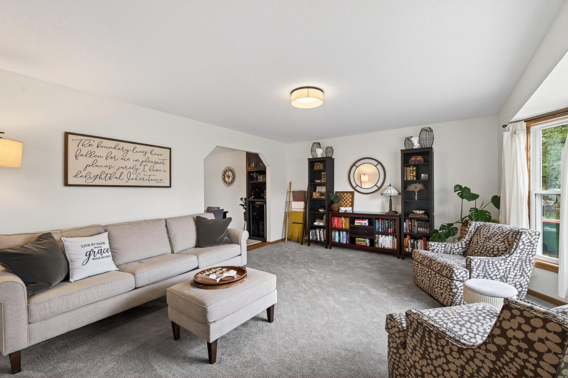 Multiple living spaces with large windows that flood the room with natural light.