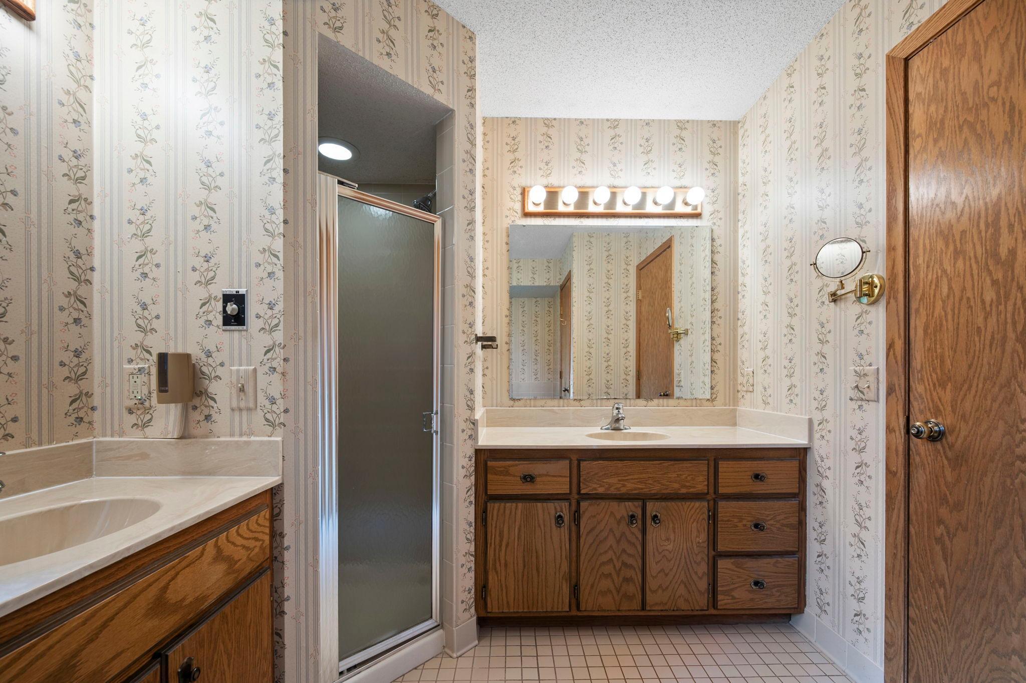Walk-through full bath has seperate shower with his and hers sinks