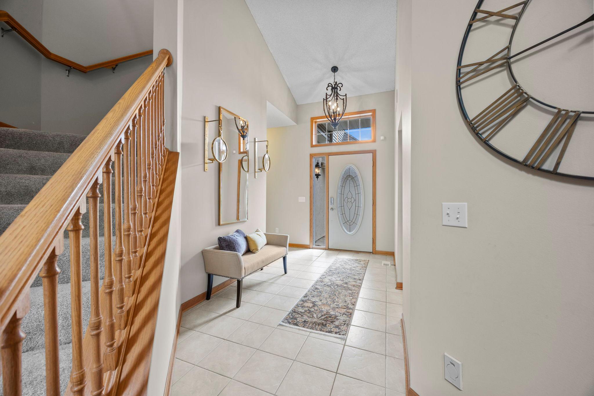 Welcome foyer with ceramic tiled floors, towering ceilings.