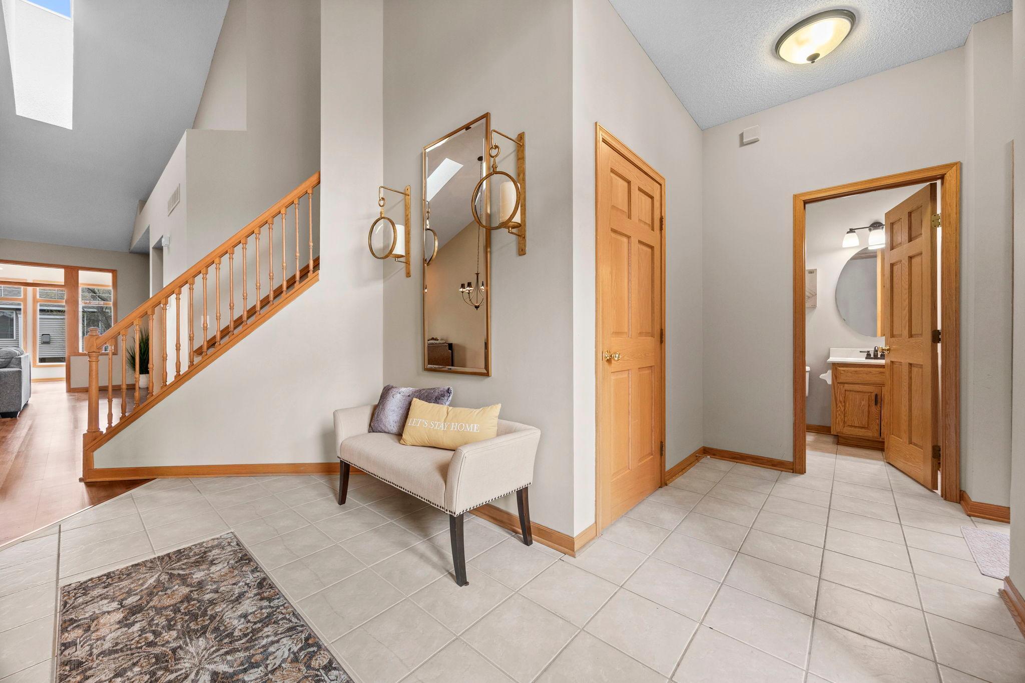 Welcome foyer with ceramic tiled floors, towering ceilings.
