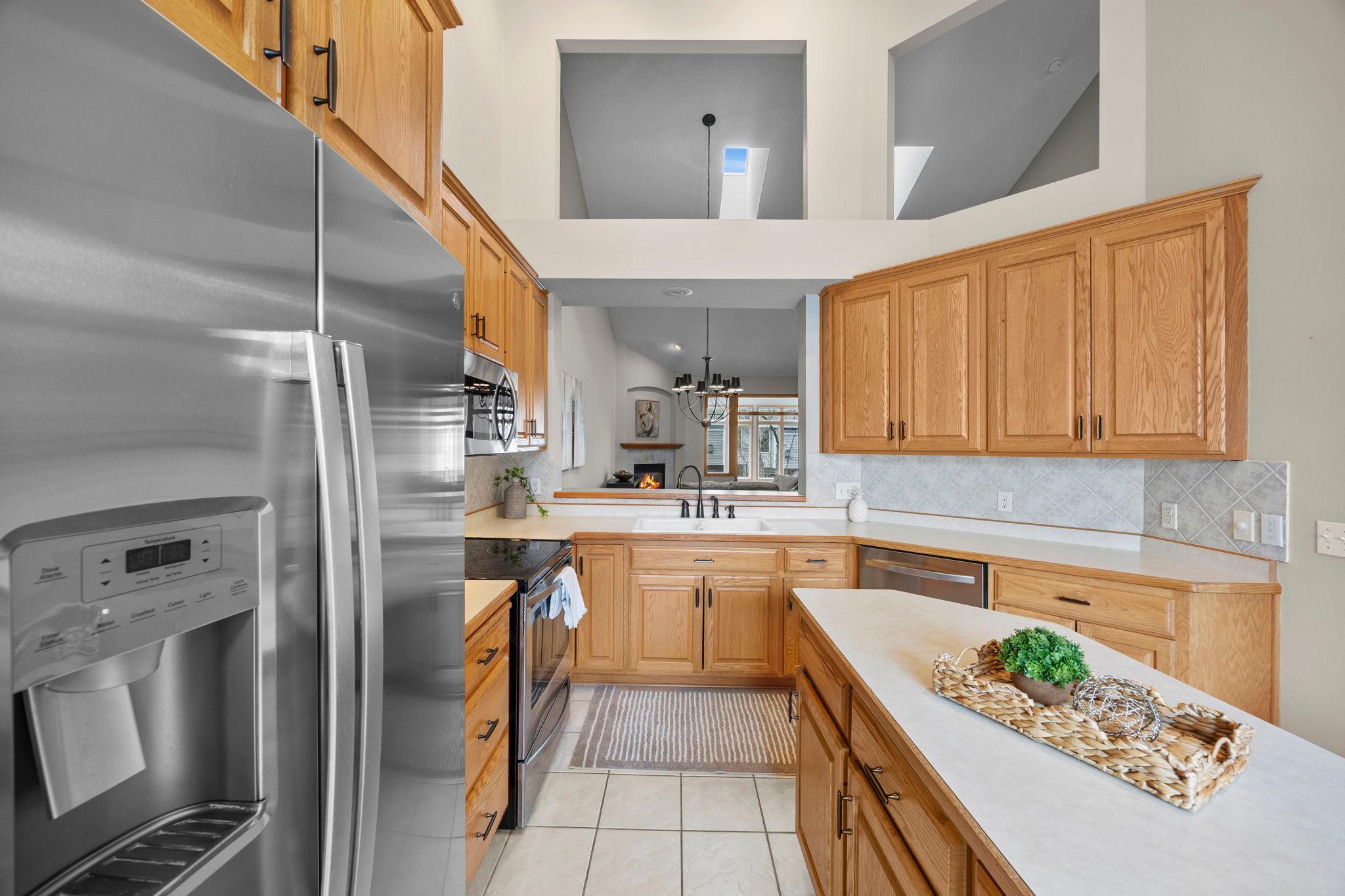 Gorgeous kitchen with center island, SS appliances and unique open space allow light to flow through this spacious townhome.