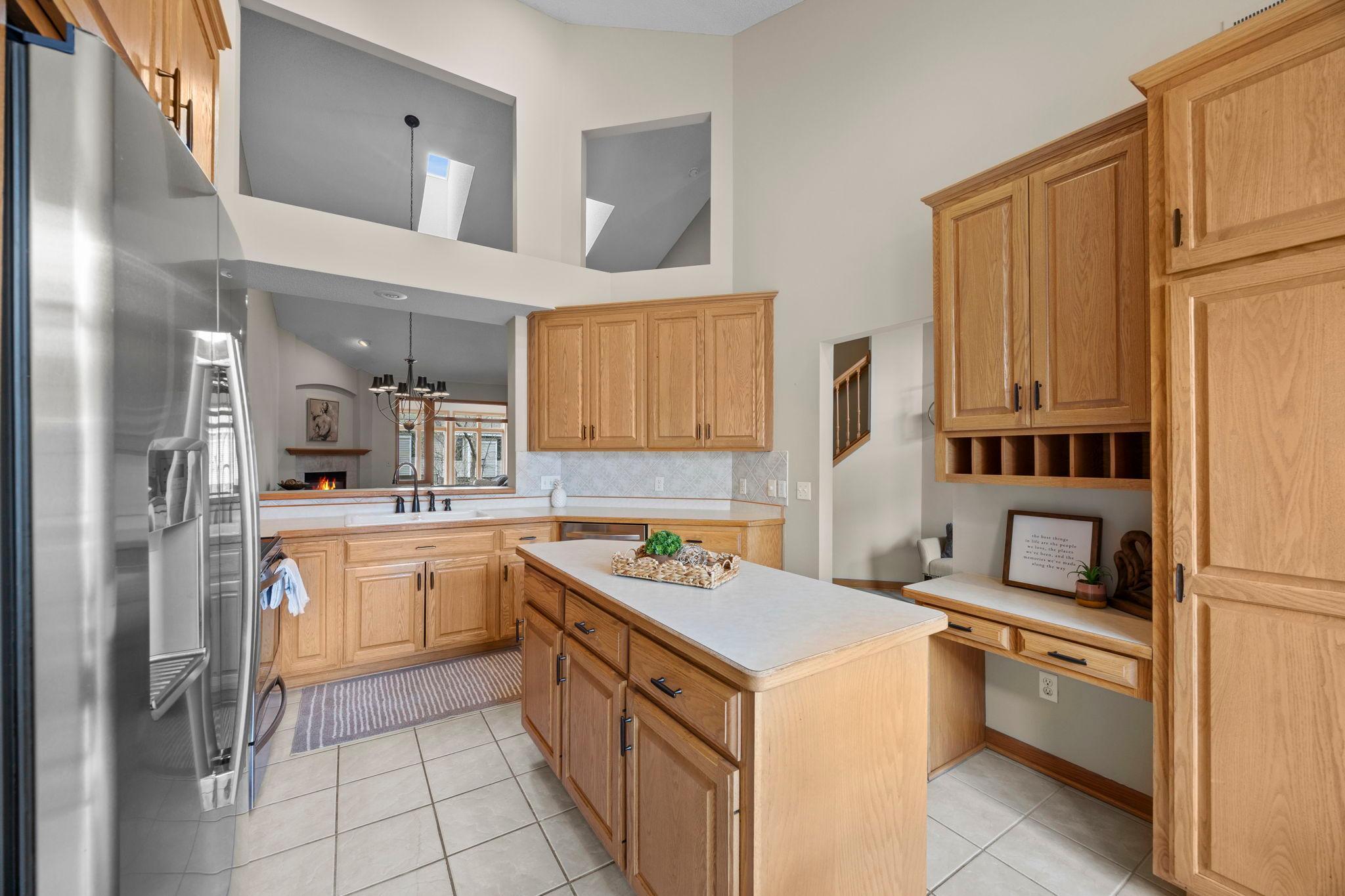 Center island and custom desk area is the command center of this fabulous kitchen space.