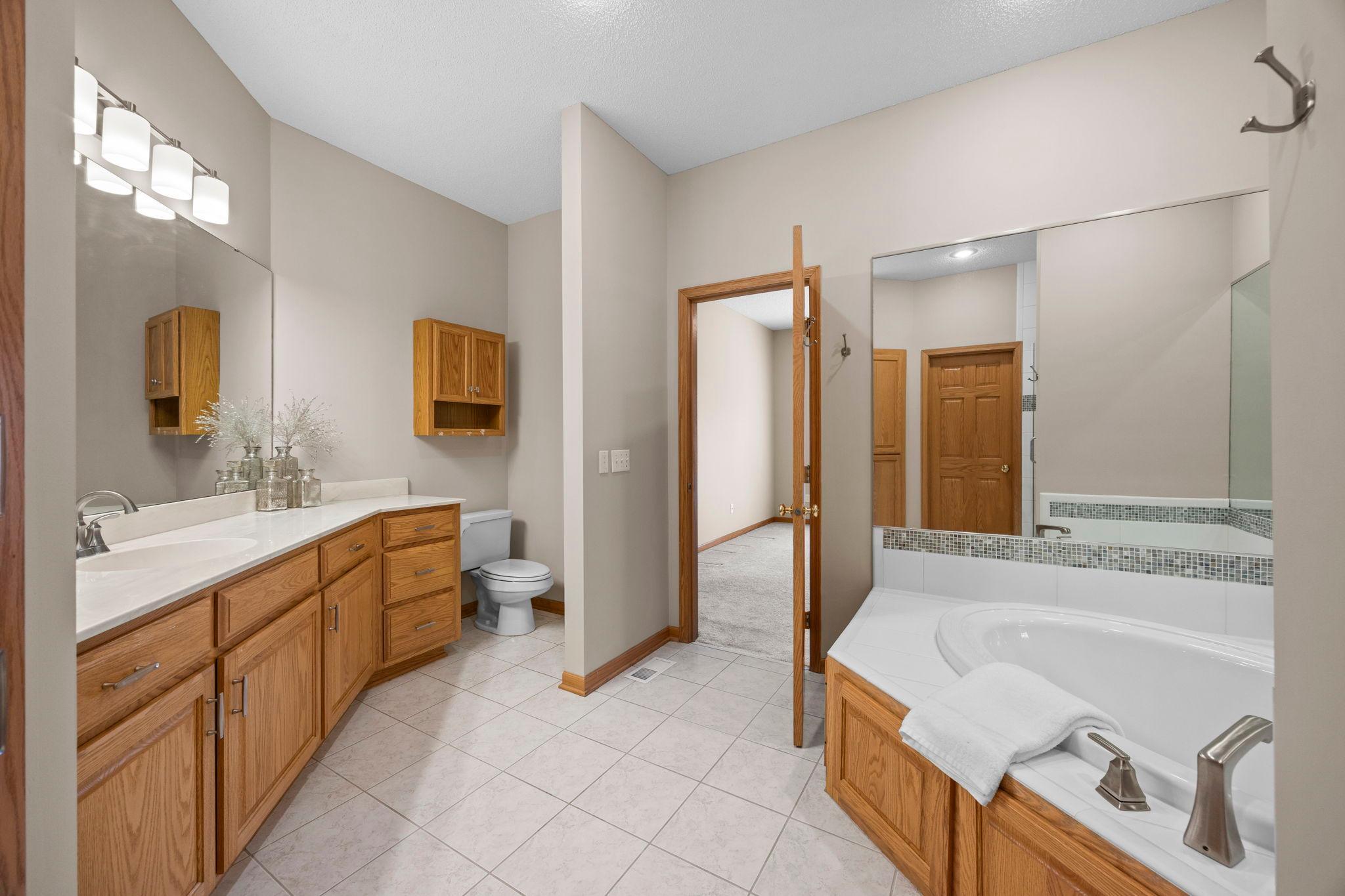 Luxury primarty bathroom with ceramic tiled floors and relazing corner, jacuzzi tub.