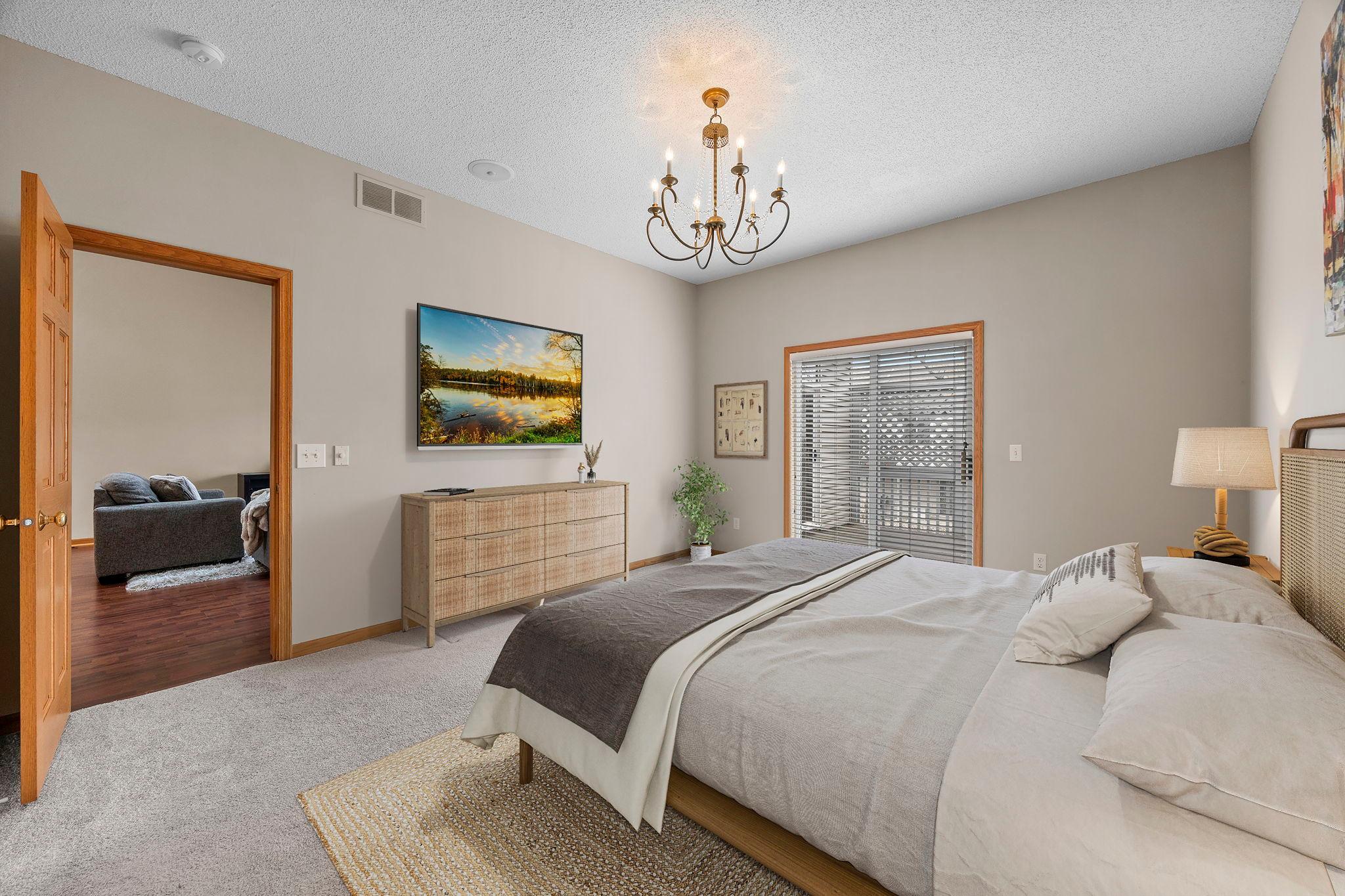 Main level Primary Bedroom walks out to private deck retreat. (virtually staged to envision the possibilities).