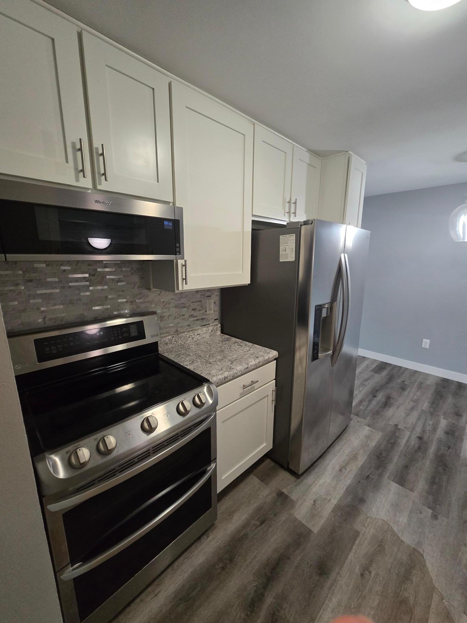 Updated kitchen with newer cabinets, counters, and appliances