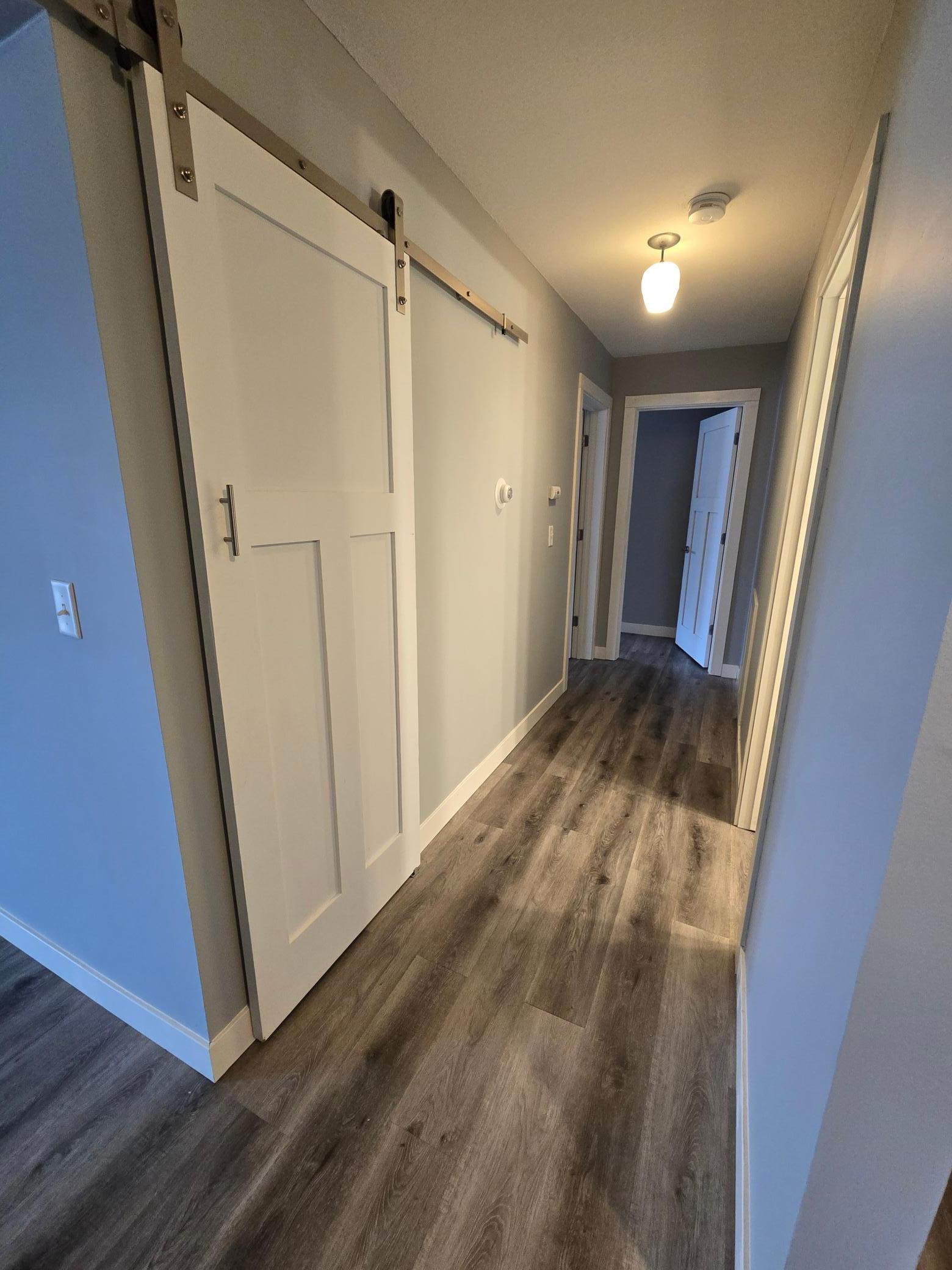 Hallway to bath and bedrooms with linen closet