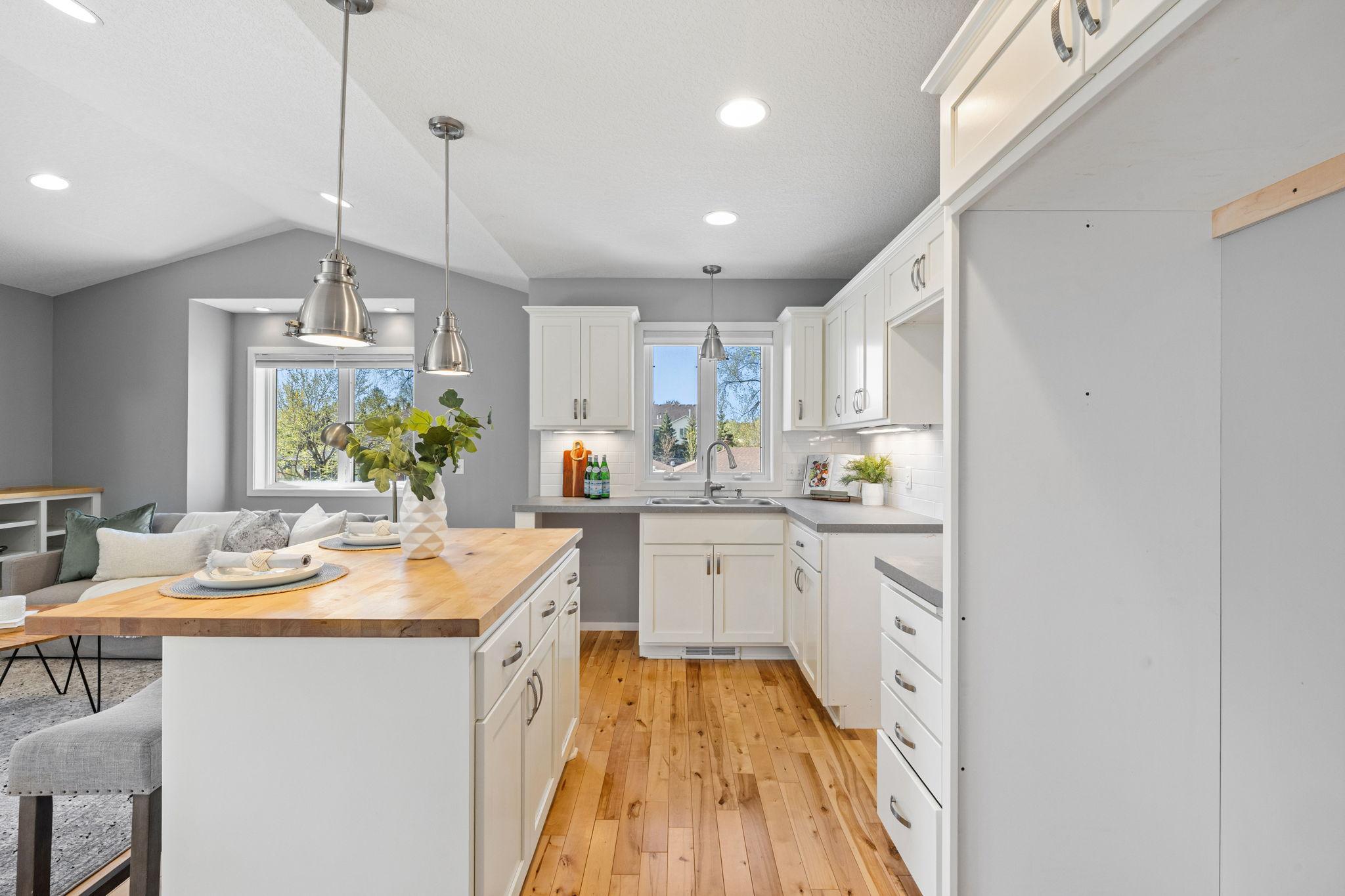 It includes a full kitchen with wood flooring and space for appliances.