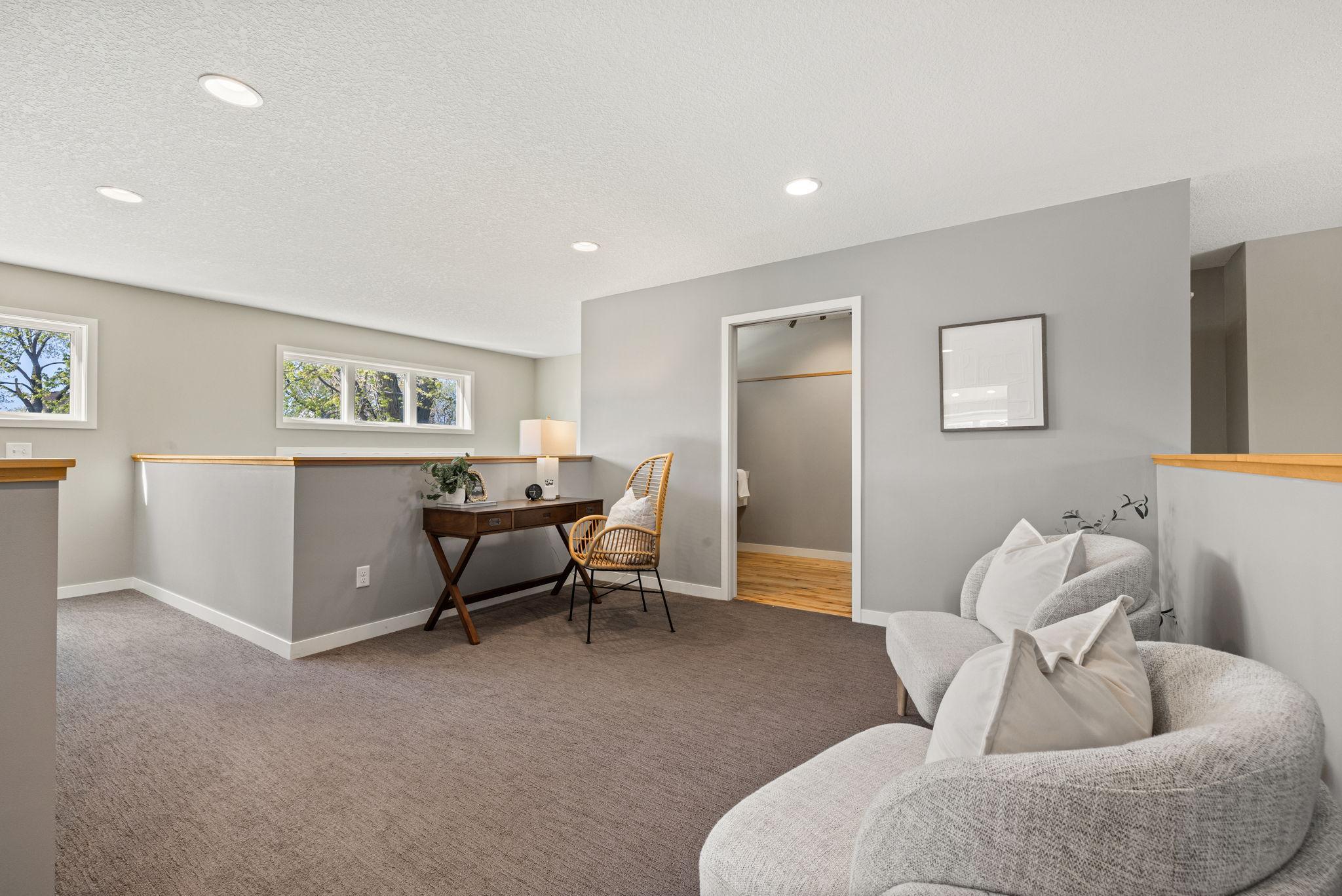 Just off the loft is a separate bonus room featuring a sink, cabinetry, and counter space.