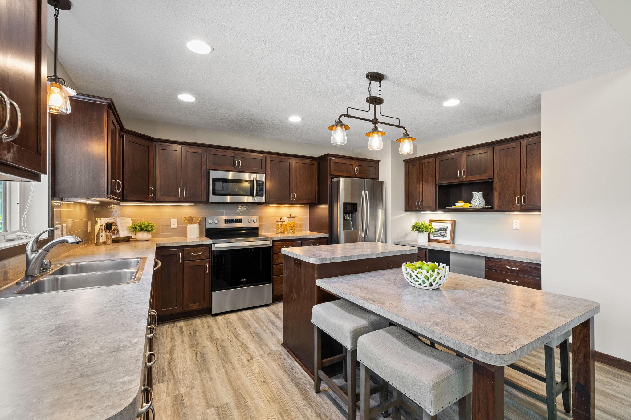 Enjoy a center island with a lower-tiered dining extension for additional seating.