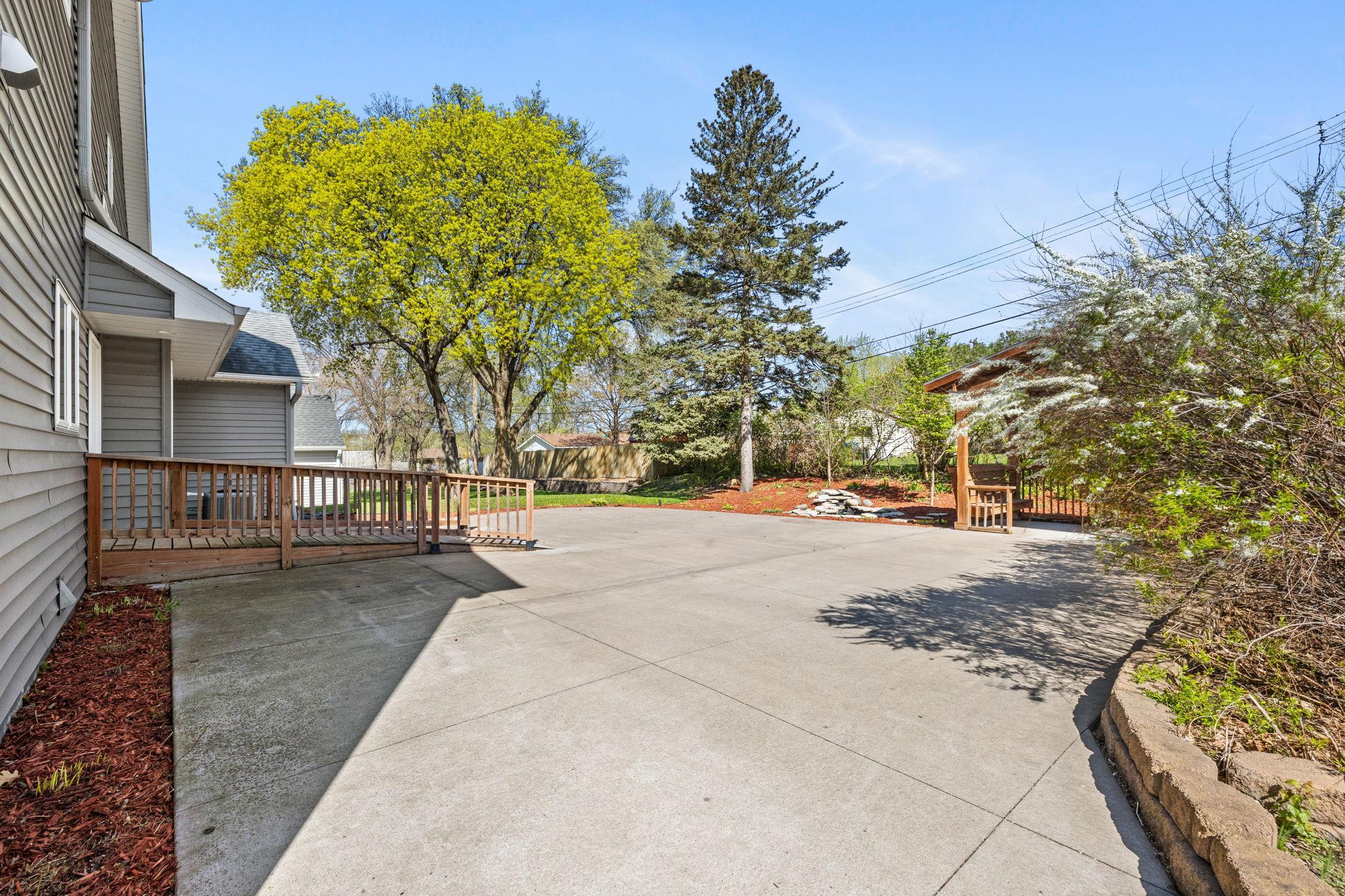 Spacious patio designed for seating, grilling, or gathering around a firepit.