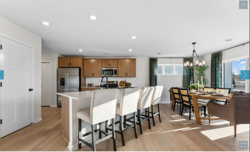 Kitchen in warm cabinetry, quartz countertops and Dining Room (staged model, representational photo for floorplan).