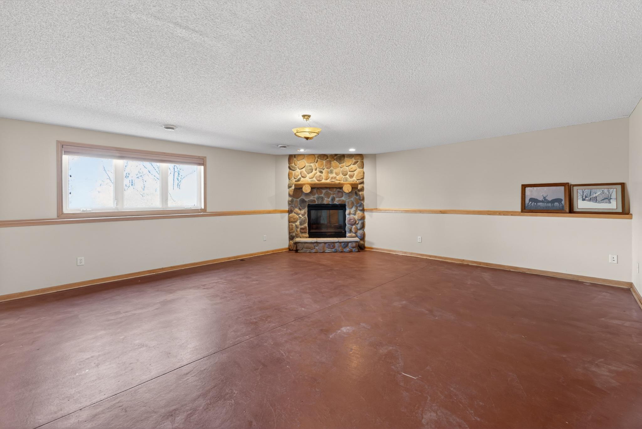 Lower level Family Room features a stone gas fireplace